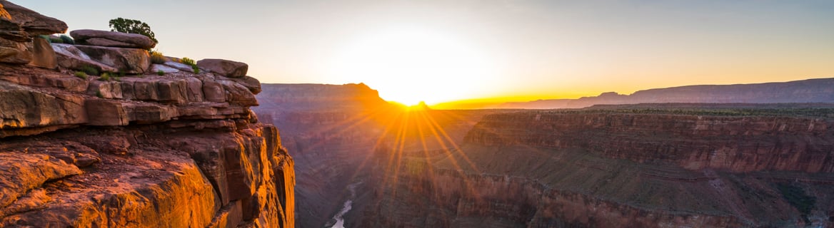 a sunset over a canyon