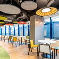 interior oficina Groupon con sillas y mesas redondas (office design Groupon with round tables and chairs)