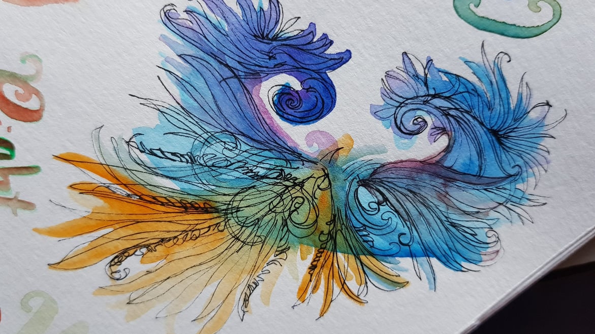 a watercolor painting in orange, blue, and purple, which organic ink swirls in pen.