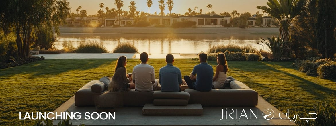Family sitting by the Nile canal at Jirian Compound