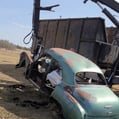 a car being picked up by a picker truck