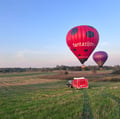 a red hot air balloon in the air vilnius