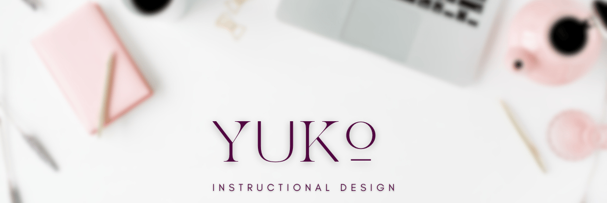 A blurry top down aesthetic desk setup with Yuko Instructional Design written.
