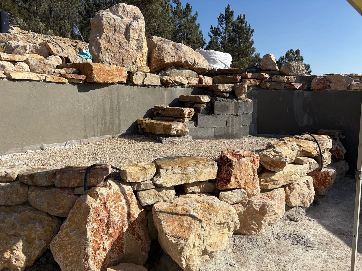 Stone soaking tub at the top of the waterfall circuit — Lisbon Natural Pool Oasis