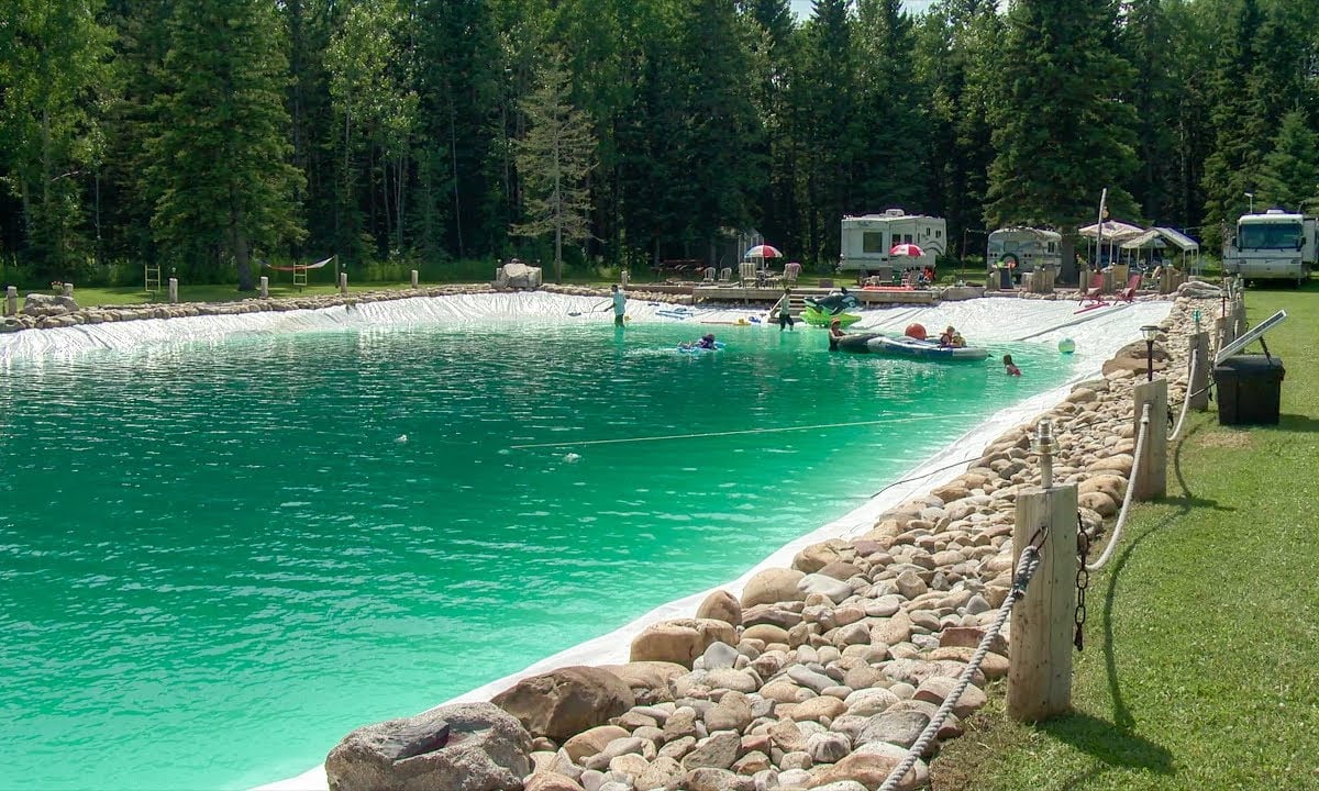 Large natural lake construction with swimming zones — engineered for clarity