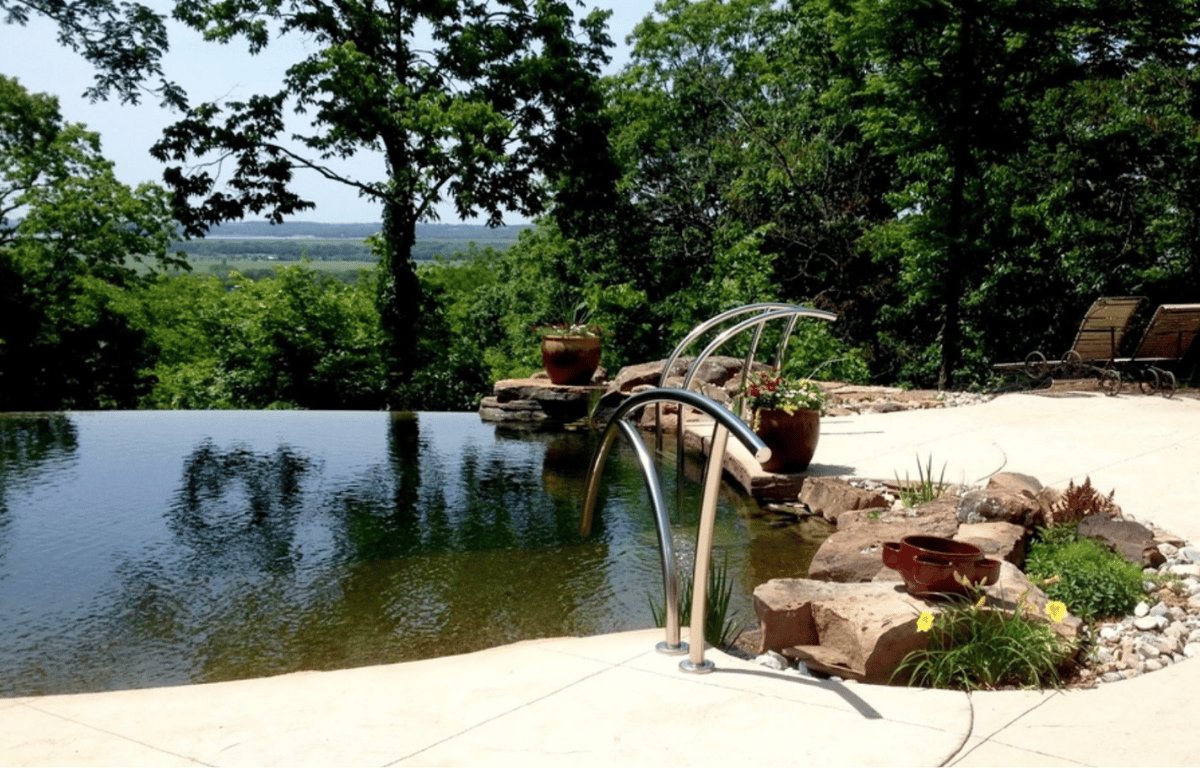 Modern plant-free biopool with infinity edge and minimal plantings