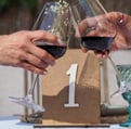 a couple of people holding wine glasses in a wedding