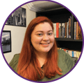 a woman with red hair and a green shirt