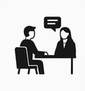 a man and woman sitting at a table with a speech bubble