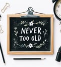 Never too old sign on a blackboard