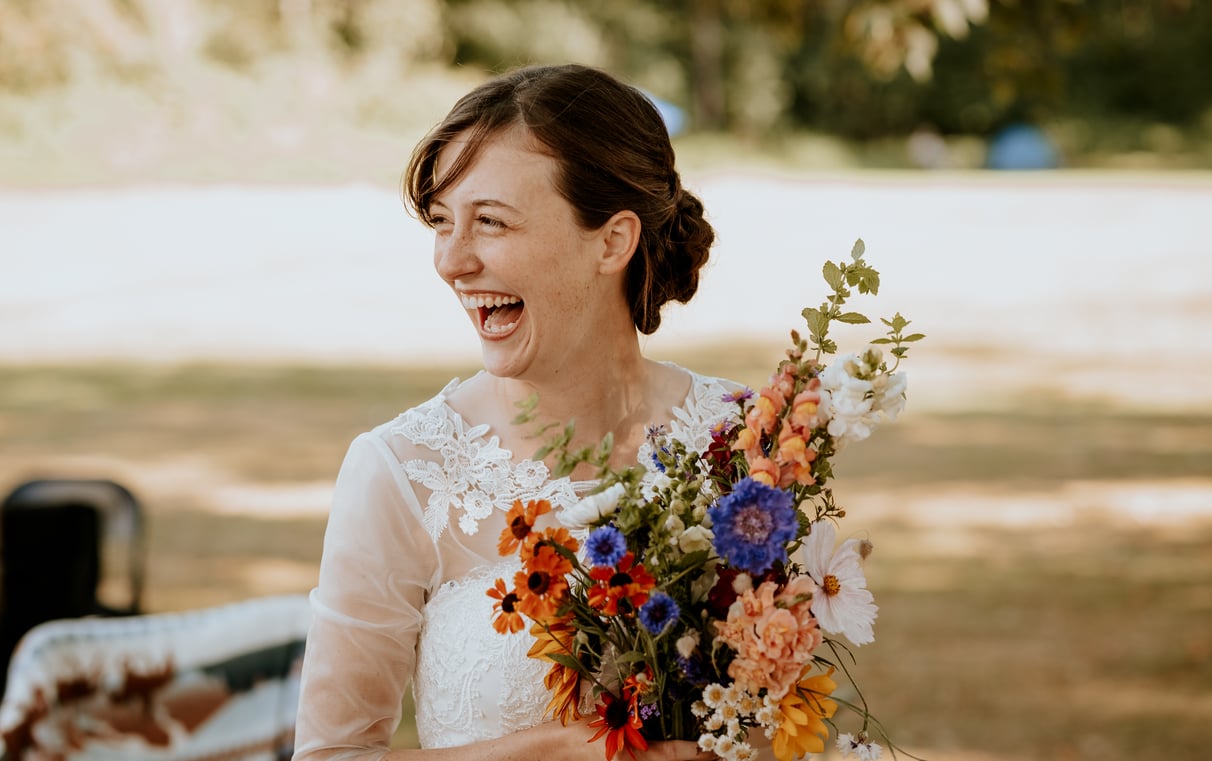 Surrey wedding photography at peace arch with bride holding flowers