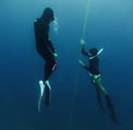 a man and woman freedive training line session