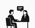 a man and woman sitting at a table with a speech bubble