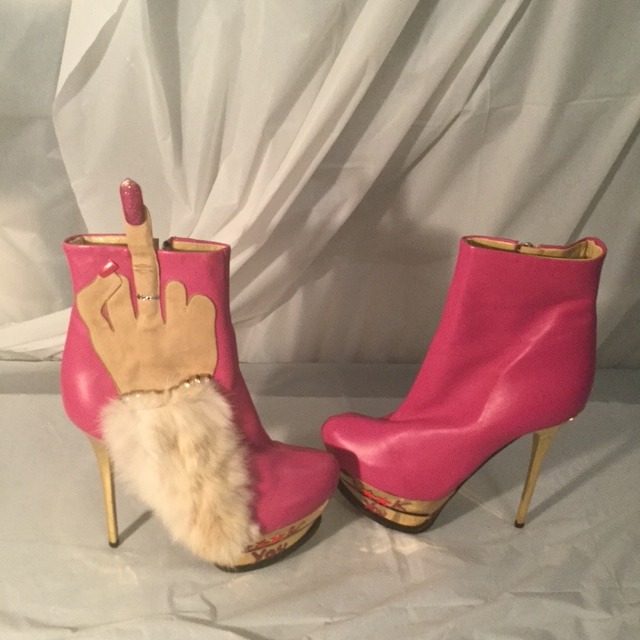 a pair of pink boots with a handmade finger - like finger - like finger