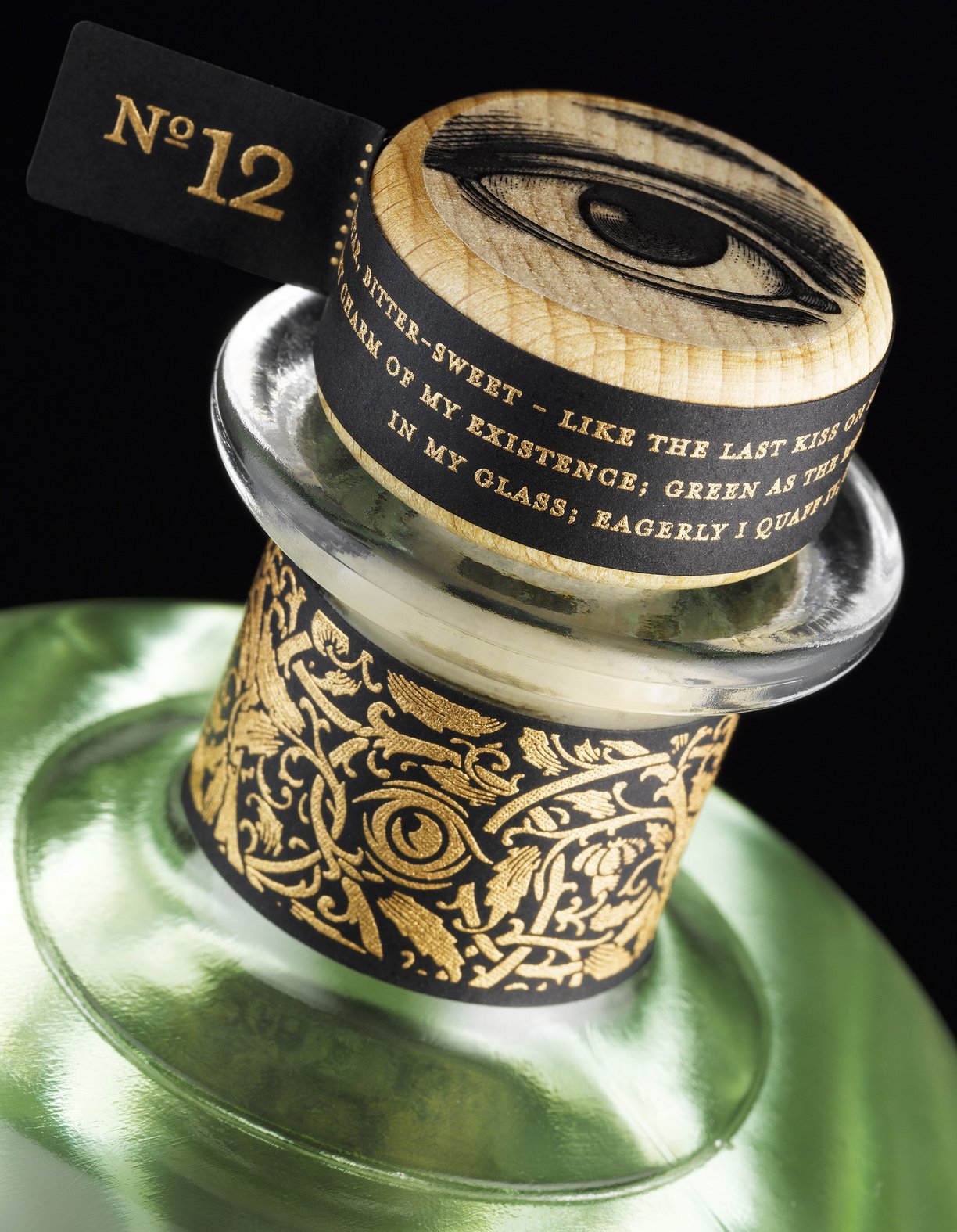 Close up of eye detail on top of green Absinthe bottle