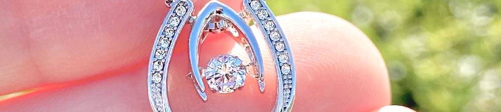 a person holding a diamond necklace with a diamond