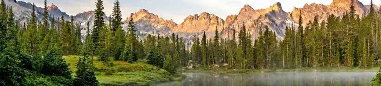 Mountains with a lake and pine trees in Idaho.