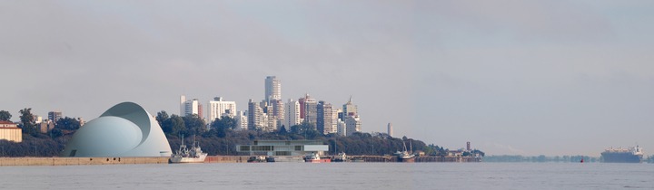 a city skyline with a large building in the background