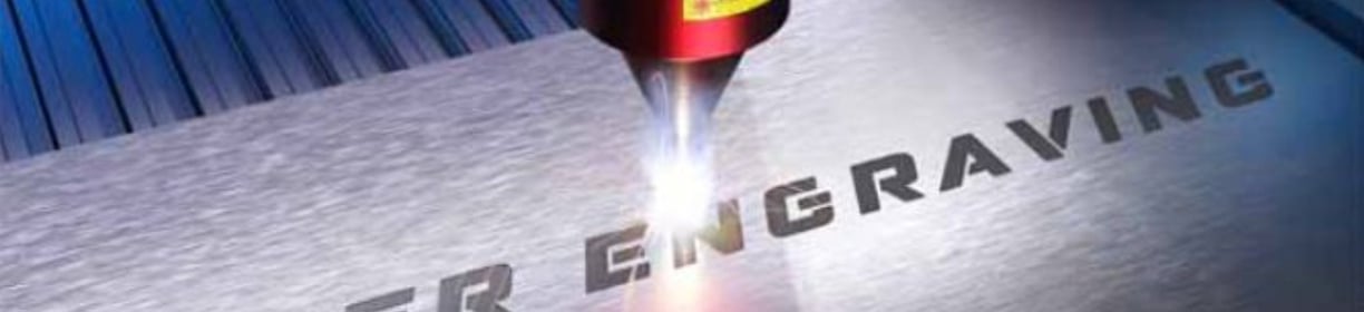Una máquina de grabado láser en el proceso de grabado de una placa de metal.