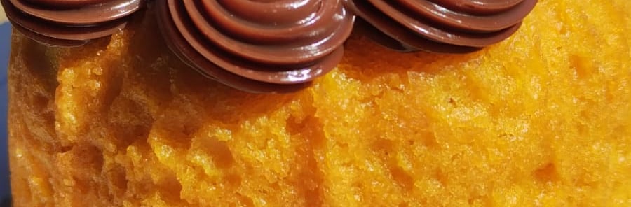 a cake with chocolate frosting on top of a white plate