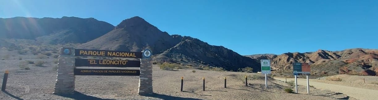 a sign that says private parking lot in front of a mountain