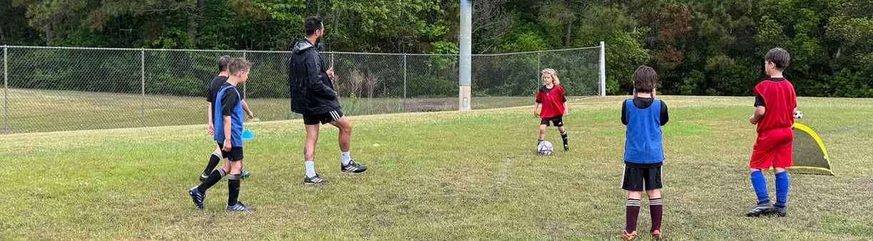 <img src="your-image-path.jpg" alt="Crestline FC coach leading a small-group soccer session with you