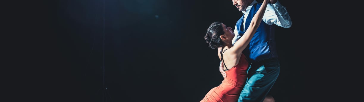 a man and woman dancing in a dance pose