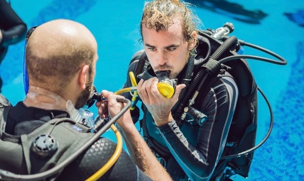 a man in a scuba suit is getting ready to go scuba
