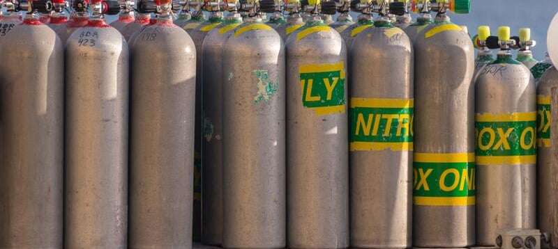 a bunch of gas bottles of gas on a trailer