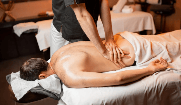 a man getting a lower back massage at a clinic