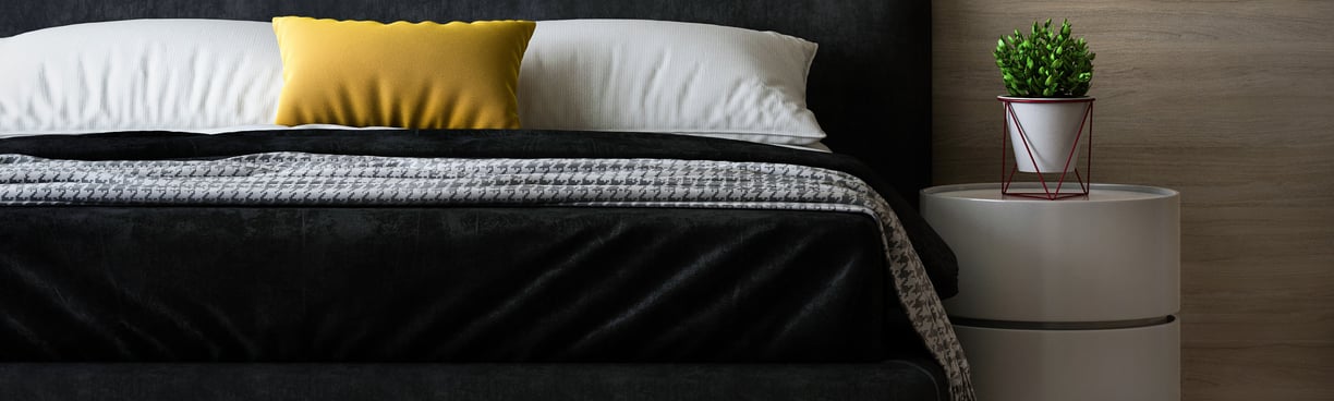 a room with bedsheet and white pillow cover
