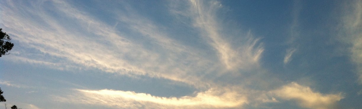  thin white clouds in blue sky