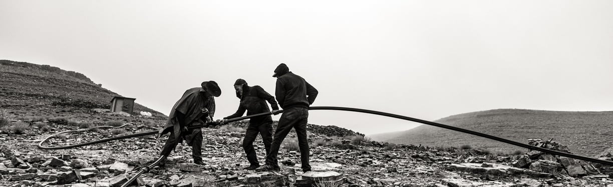 a group of men working on a rocky mountain