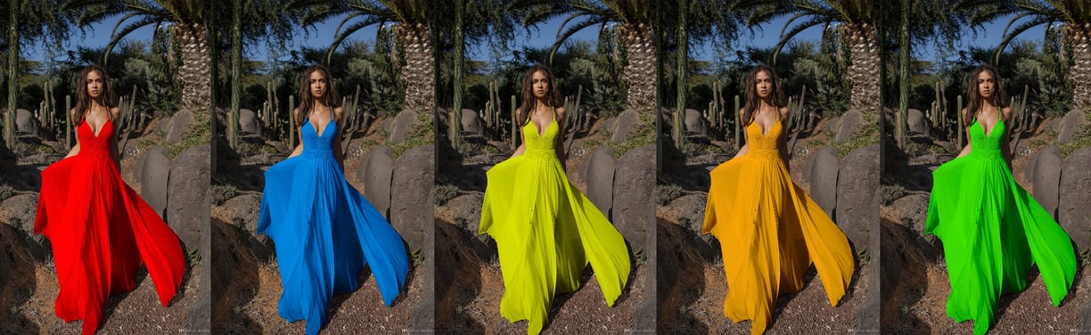 a woman in a colorful dress standing in front of a tree