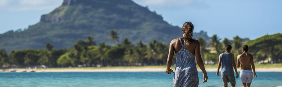 a group of travelers walking on the beach of Mauritius