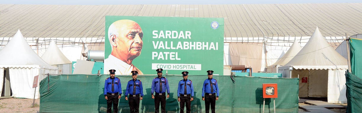a group of police officers standing in front of a large billboard