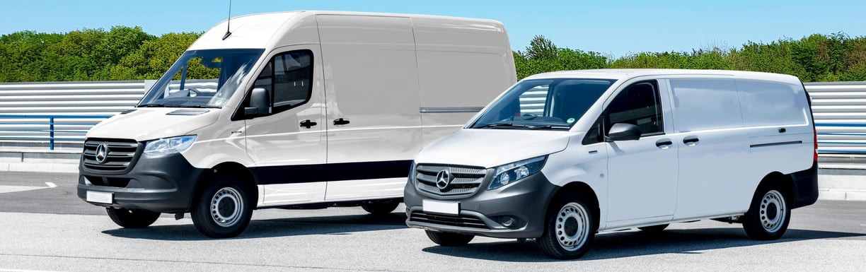 two vans parked in a parking lot