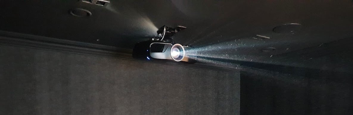 Epson projector mounted on a ceiling in a home cinema room