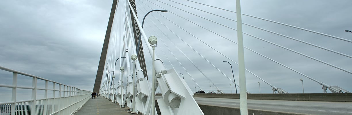 a bridge with a white bridge and a street light