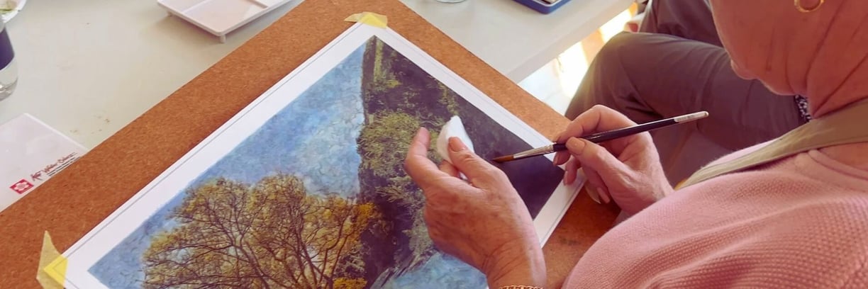 Woman creating a fine art photograph using a paint brush