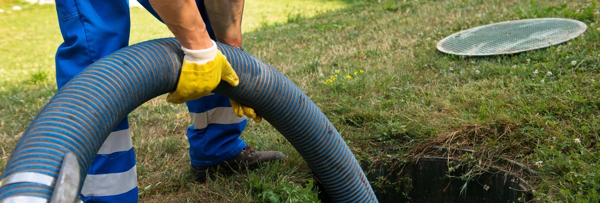 Worker pumping Septic Tank