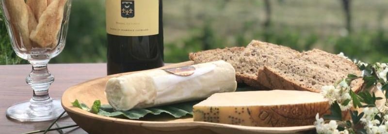 a bottle of wine and breadstickers on a table