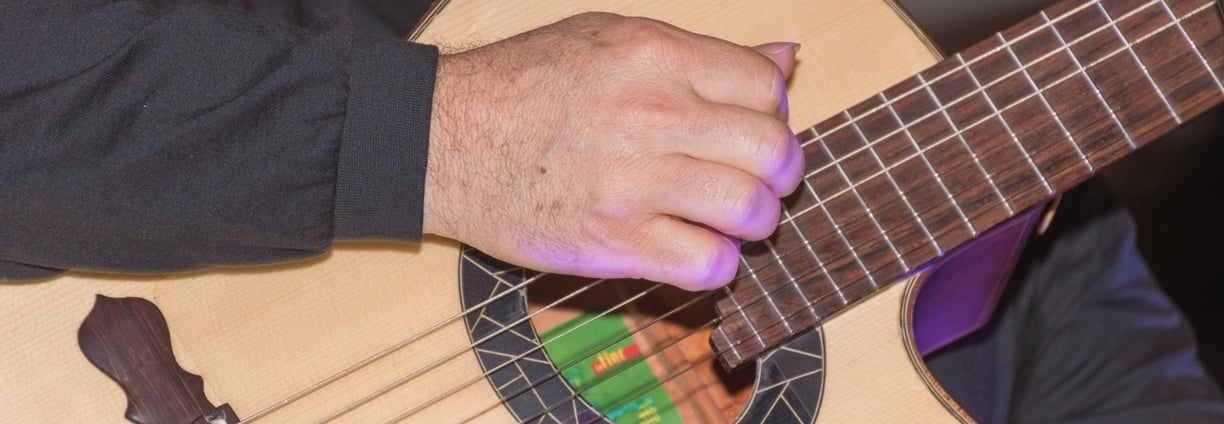 a man playing a guitar in a room