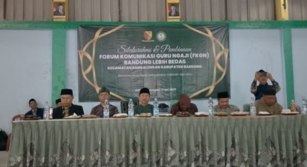 a group of people sitting at a table with a banner on it