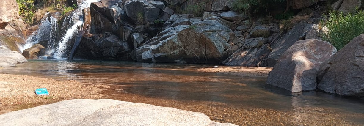 a small waterfall in a stream in a rocky river