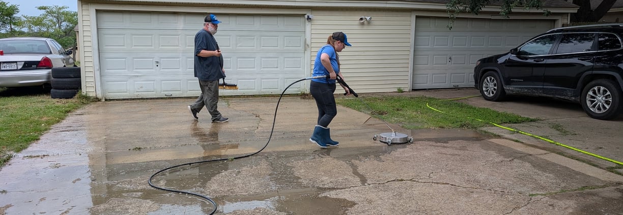 Team surface cleaning a residential driveway in Denton Texas.