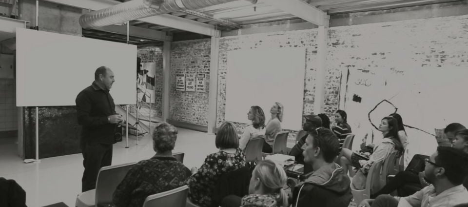 Martin Osner teaching a group of students in a workshop at the Photography School and Art Academy.