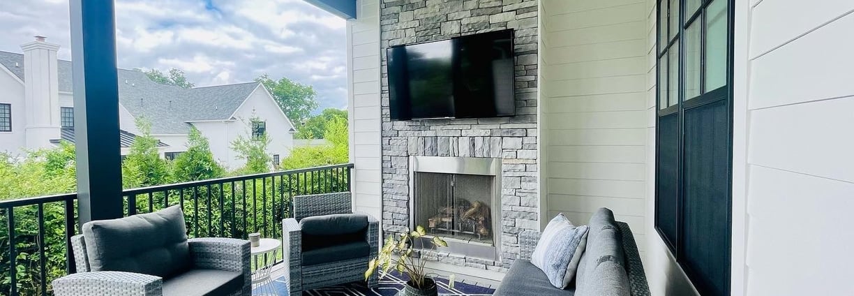 Outdoor tv mounted over stone wall.