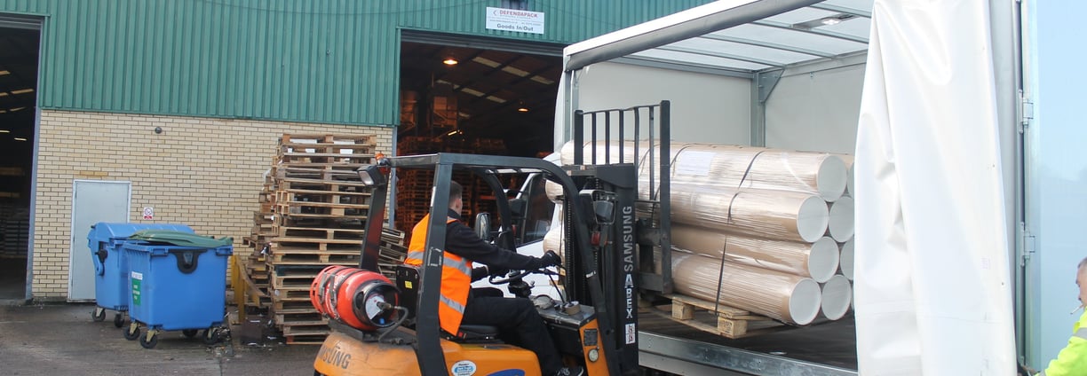a forklift truck carefully loading a urgent same day delivery