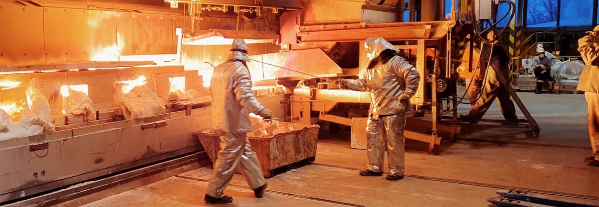a man and woman working in a factory